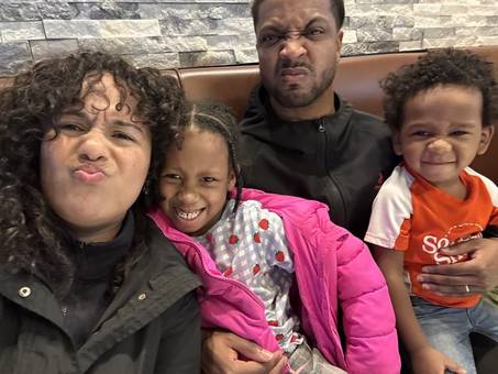 Jessenia and friends making silly faces with two children