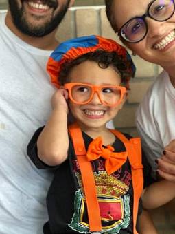 A boy in orange glasses and a bow tie