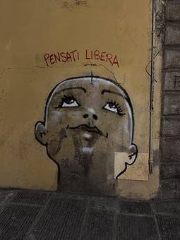 Street art in Florence with the words Pensati libera