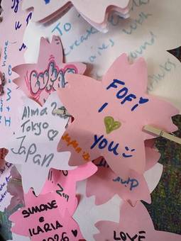 Handwritten notes on pink paper cherry blossoms in Tokyo