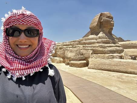 Jessenia in a red and white scarf in front of the Sphinx